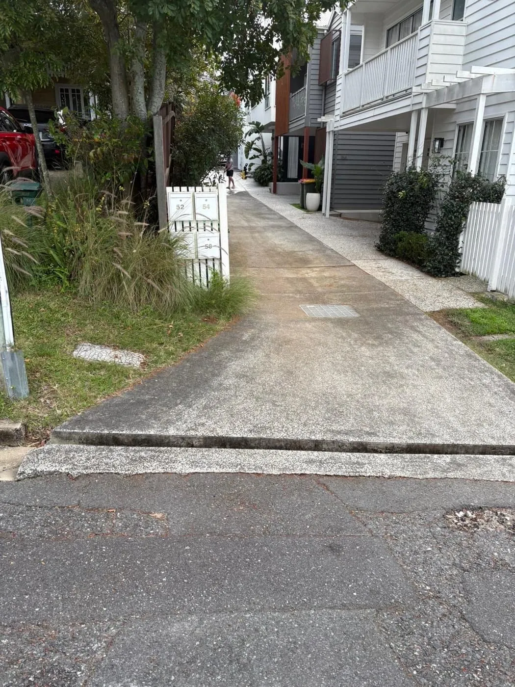 A residential driveway after pressure cleaning, even pale concrete with no staining.